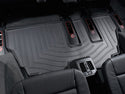 A close-up view of black WeatherTech FloorLiner for BMW X5 (E70) 2007-2013 3rd row installed in a vehicle’s rear, offering superior floor protection and showing visible air vents behind the center console.