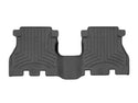 The WeatherTech Floor Liner HP for Jeep Wrangler 4-Door (2018-) is a black, contoured rubber rear floor mat with raised edges and grooves, offering superior protection by covering both sides and the center hump.