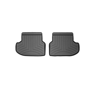 The WeatherTech Floorliner for BMW 5 Series Sedan (2013-2016) F10, shown in black with raised edges and grooves, offers reliable second-row carpet protection. Two mats are displayed side by side on a white background.