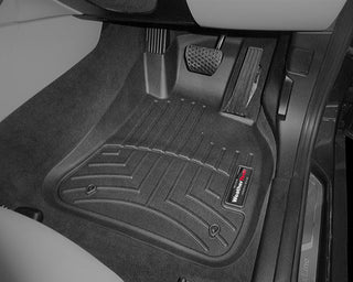 Close-up of the Weathertech Floorliner for BMW X1 AWD Auto (2009-2015)(E84) 1st Row, featuring textured grooves and black rubber for superior driver’s side protection, shown over dark carpet against light upholstery.