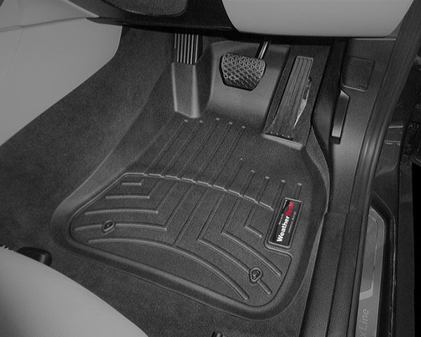Close-up of the Weathertech Floorliner for BMW X1 AWD Auto (2009-2015)(E84) 1st Row, featuring textured grooves and black rubber for superior driver’s side protection, shown over dark carpet against light upholstery.