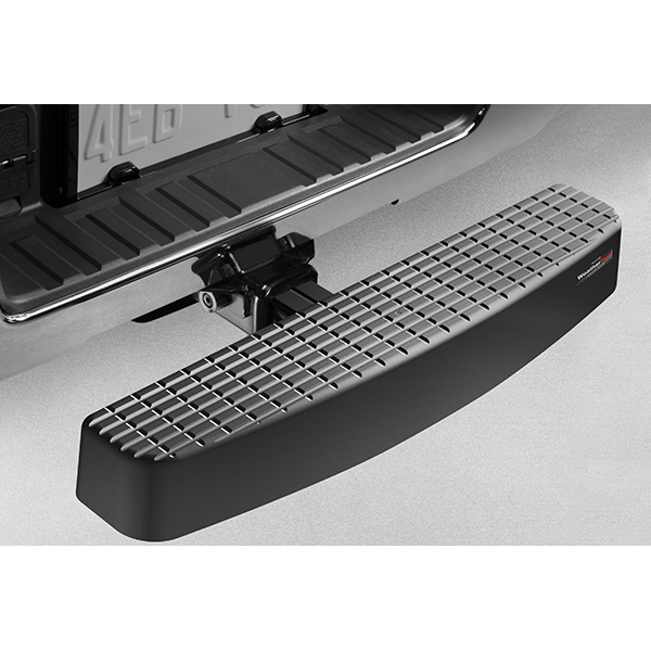 A close-up of the Weathertech BumpStepXL 24 – AU Version (Standard Plated Hitch Hardware), in black, attached to the receiver hitch with a textured surface for traction, located below the tailgate and license plate for bumper protection.