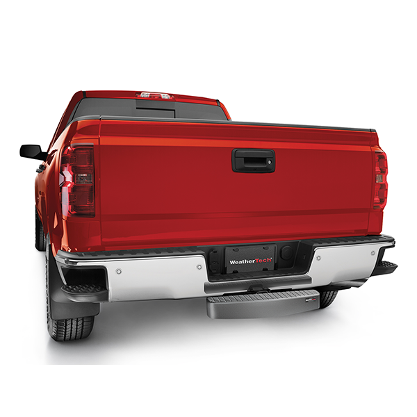 A red pickup truck seen from the rear displays a WeatherTech BumpStepXL 24 - AU Version (Standard Plated Hitch Hardware) on its bumper and a WeatherTech license plate, all set against a white background.