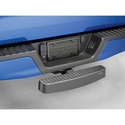 A close-up of a blue truck’s rear bumper shows a Weathertech BumpStepXL 24 - AU Version with standard plated hitch hardware mounted in the receiver hitch, providing bumper protection and easier access to the truck bed.