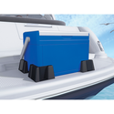 A blue cooler with a white lid and handle sits on a boat deck, elevated by four black Weathertech Cargo Tech supports. The boat floats on water under a blue sky, with birds in the background.
