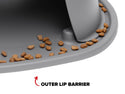 Close-up of brown pet food around the edge of a WeatherTech Double Elevated Pet Feeding System bowl with a gray spill-proof raised lip barrier. Text below reads OUTER LIP BARRIER, highlighted by a red upward arrow.