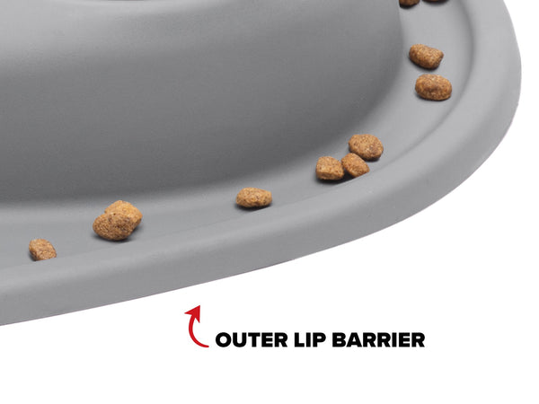 A close-up of the WeatherTech Double Compact Pet Feeding System by WeatherTech shows scattered kibble and a label highlighting its outer lip barrier, emphasizing its ergonomic, space-saving pet feeder design.