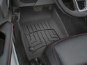 Close-up of a Jeep Wrangler 4-Door (2018-) second-row driver-side floor with a black WeatherTech Floor Liner HP featuring grooved patterns for superior protection. The car seat is black leather with red stitching. Brand: WeatherTech.