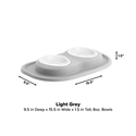 The WeatherTech Double Compact Pet Feeding System by Weathertech features two ergonomic 8 oz bowls on a light grey rectangular base, measuring 9.5" deep, 15.5" wide, and 1.5" tall—a space-saving and stylish solution for pet feeding.