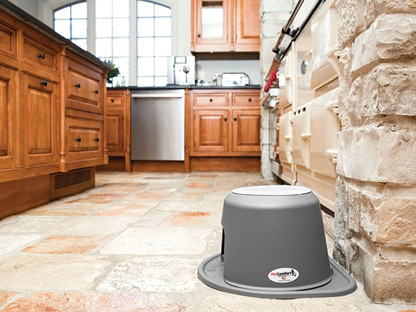 The WeatherTech Single Elevated Pet Feeding System by Weathertech, in gray, is shown on a tiled kitchen floor with wooden cabinets, stone accents, and stainless steel appliances in the background.