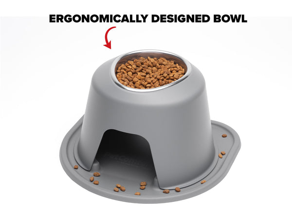 A gray WeatherTech Single Elevated Pet Feeding System with kibble inside features a user-friendly, ergonomic design. Some kibble is scattered near the base, while a red arrow highlights the bowl opening for easy access.