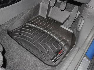 Close-up of a Mini Clubman F54 (2015-) 1st Row Floorliner by WeatherTech, showing black grooves and raised edges for superior floor protection while preserving the interior carpet under the pedals and entire footwell.