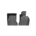 WeatherTech FloorLiner for BMW 5 Series Sedan/Wagon (2014-2017, F10/F11), 1st Row, features two black custom-molded mats with grooved patterns and red and white logo tags, offering premium protection for your car’s interior.