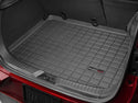 A close-up of the open trunk of a Mazda CX-3 (2016-2021) with a WeatherTech Cargo Liner. The raised grid pattern provides complete cargo area protection, fitting snugly to cover the entire trunk floor.