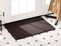 A WeatherTech Carpet Mat from Weathertech sits on white tile flooring with black diamond patterns in front of a white door with glass panels, while a beige coat hangs on a rack nearby.