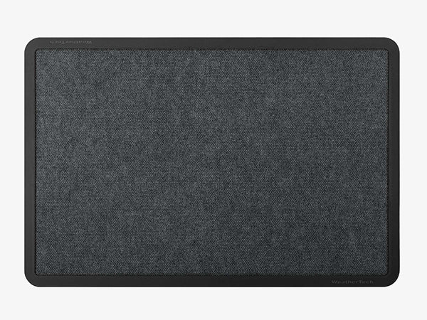 A WeatherTech Carpet Mat by Weathertech, rectangular and commercial-grade, features a dark gray textured fabric surface with a black border, seen from above on a plain light background.