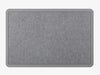 The WeatherTech Carpet Mat by Weathertech is a rectangular, gray fabric desk mat with rounded corners and a darker gray border, styled like a commercial-grade doormat and shown on a light gray background.