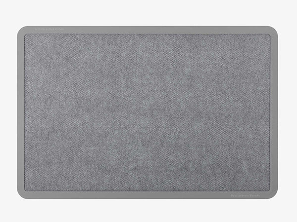 The WeatherTech Carpet Mat by Weathertech is a rectangular, gray fabric desk mat with rounded corners and a darker gray border, styled like a commercial-grade doormat and shown on a light gray background.