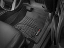 Driver-side view of a Toyota Land Cruiser Prado J150 (2010-) interior with a custom-fit black WeatherTech Floorliner – 1st Row, designed with raised grooves for trapping dirt and moisture and providing better protection than standard carpet liners.